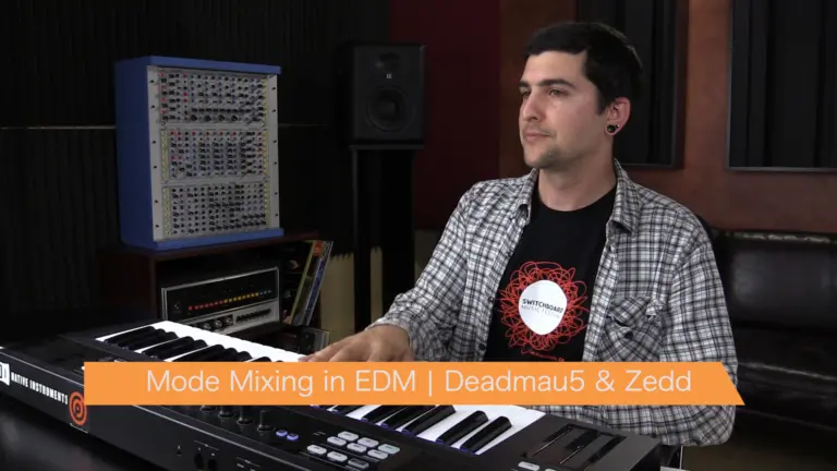 A man sitting in front of a keyboard, using a music production program to create beats and make mood-making music online for free.