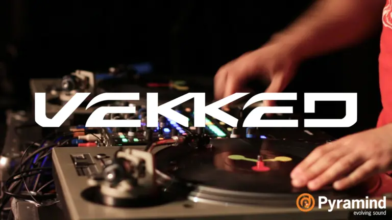 A man mastering and mixing on a turntable with the word vekked.