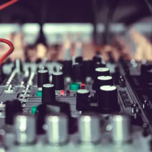 A close up of a dj mixer with wires on it, perfect for music production online free.